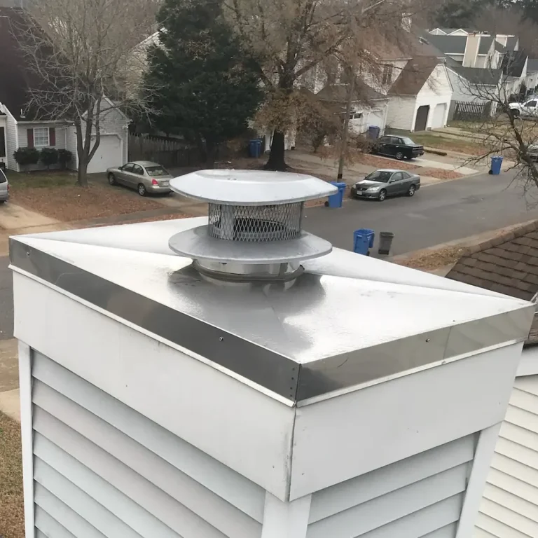 Stainless steel chimney cap and chase cover installed on a prefab chimney in Newport News, Virginia