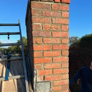 Masonry chimney leak repair with crown sealing and repointing in Newport News