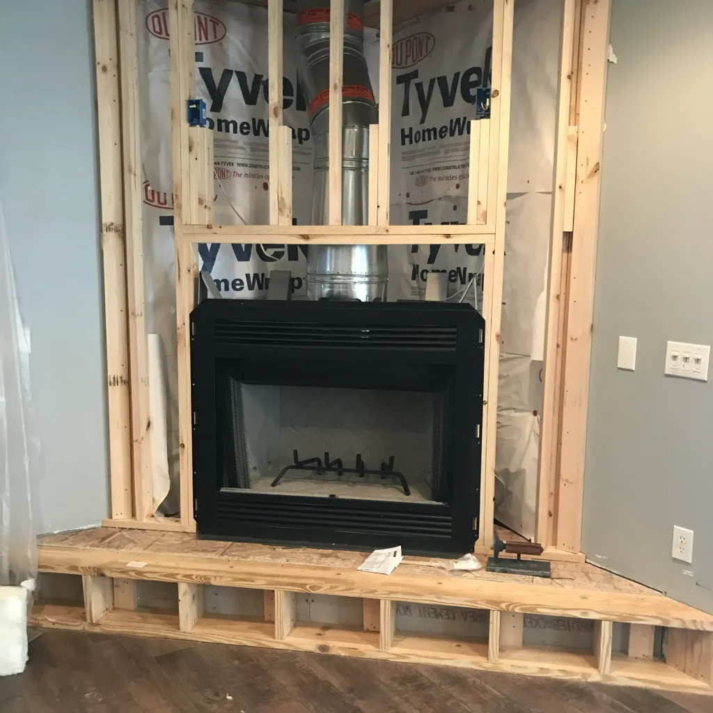 wood burning fireplace installation with new prefab chimney