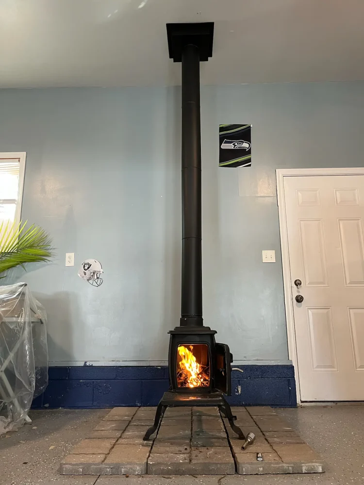 Wood burning stove installation in Norfolk, VA by Premier Chimney and Roofing.