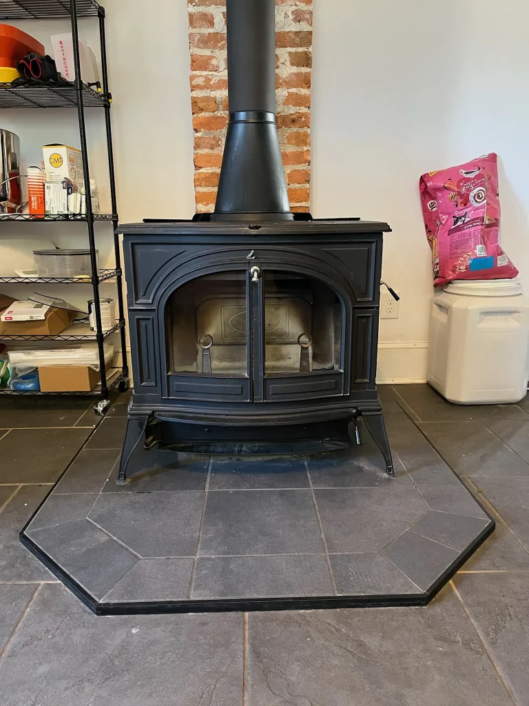 Freestanding wood stove professionally installed by Premier Chimney and Roofing in Hampton Roads.