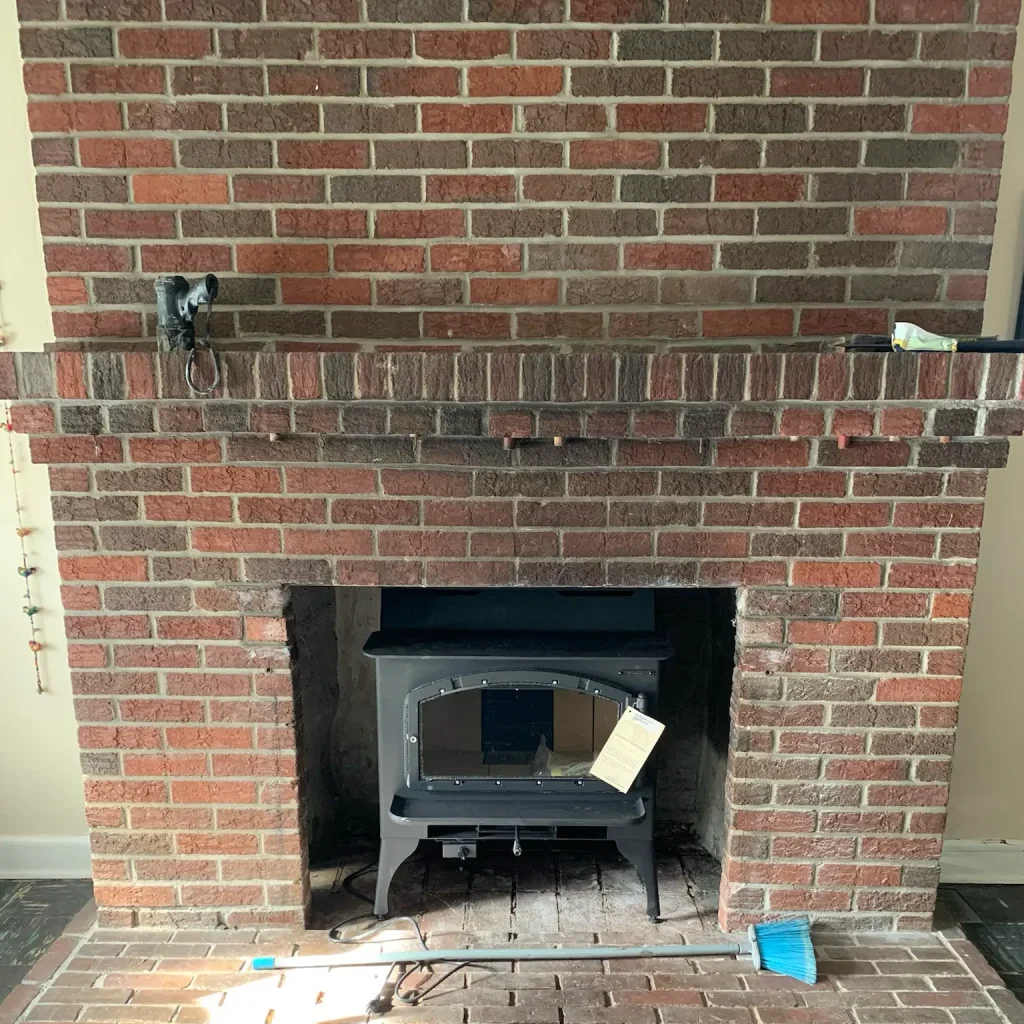 Wood burning stove installation in Norfolk, VA by Premier Chimney and Roofing.