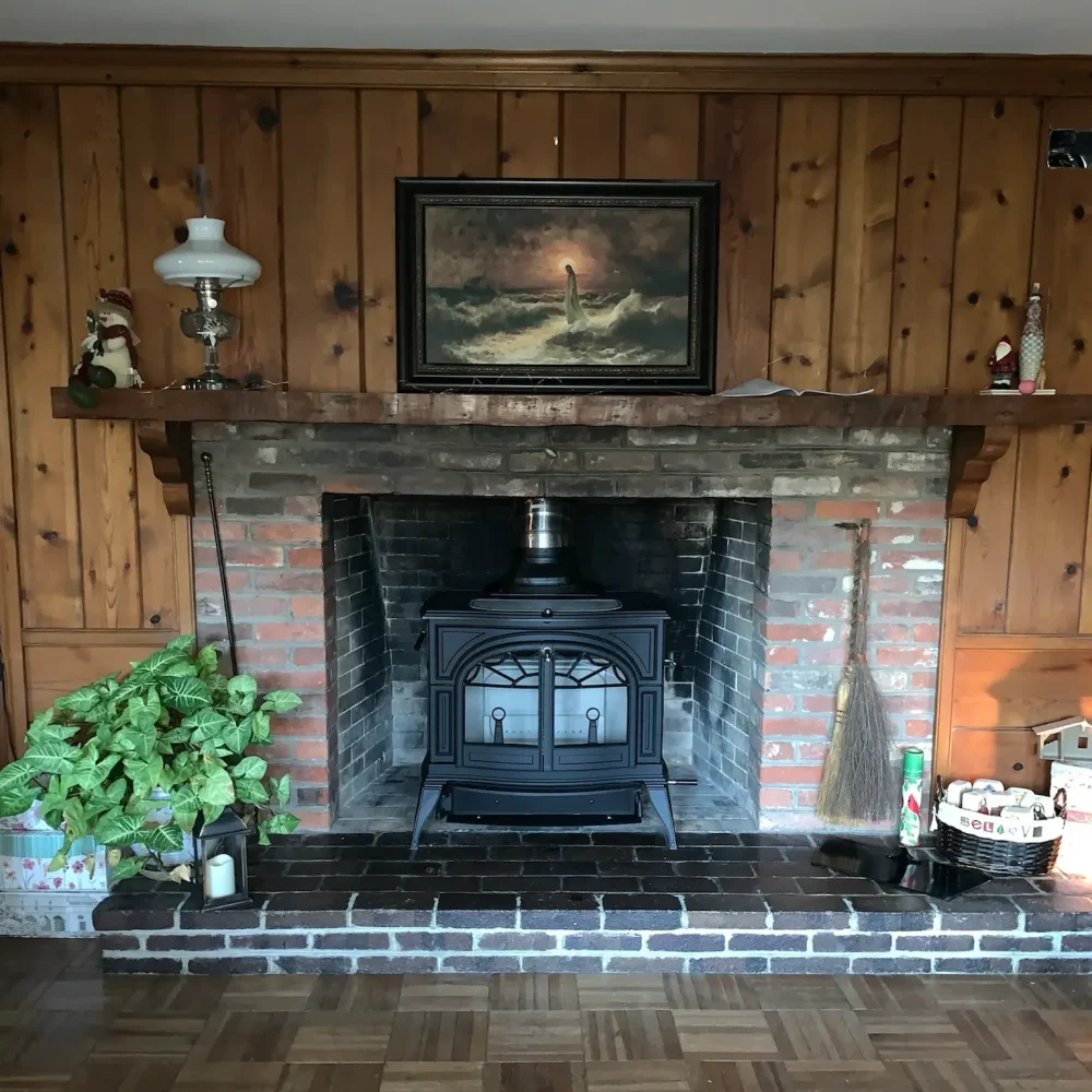 Wood burning stove installation in Norfolk, VA by Premier Chimney and Roofing.