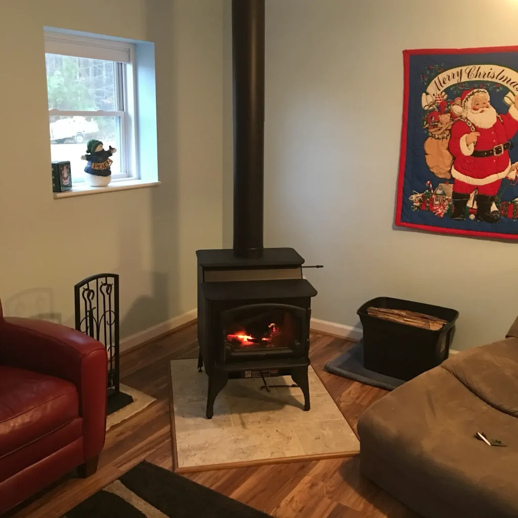 Freestanding wood stove fully installed in Virginia Beach, VA with proper venting, wall clearance, and non-combustible hearth.