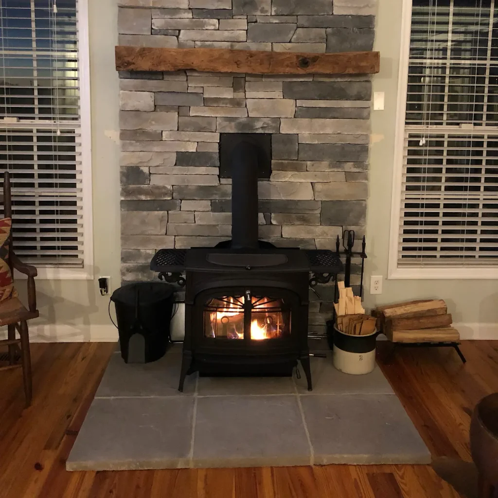 Freestanding wood stove fully installed in Virginia Beach, VA with proper venting, hearth protection, and code-compliant clearances.