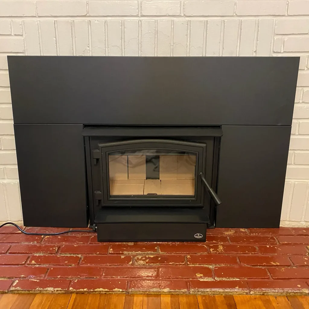 Wood burning stove installation in Norfolk, VA by Premier Chimney and Roofing.