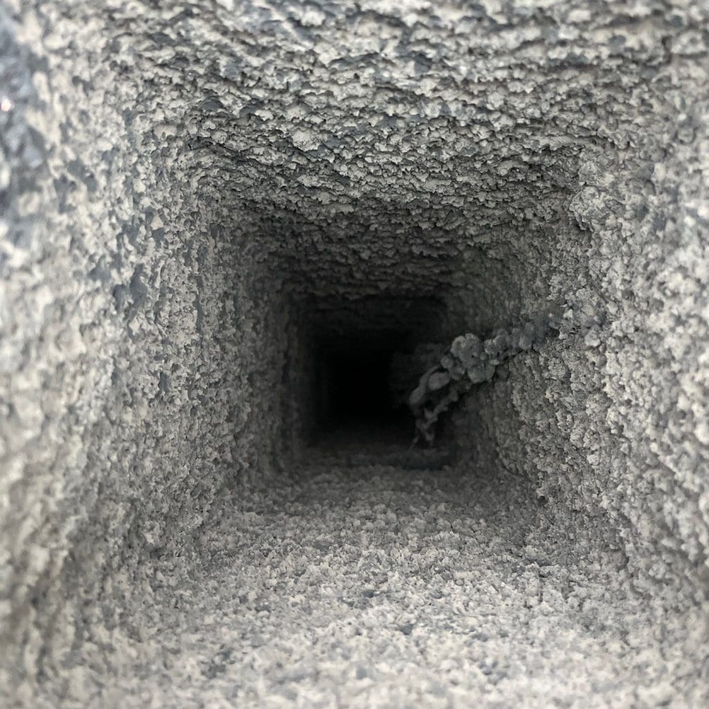 A dirty chimney before a chimney sweep.