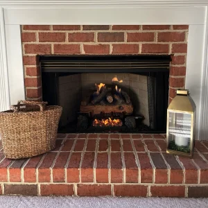 Repaired gas fireplace in a Virginia Beach living room with a clean, consistent flame and newly installed gas logs.