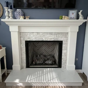 A new gas fireplace installed in Chesapeake, VA with custom mantel and stone finish.