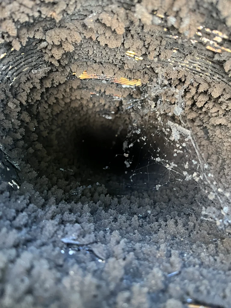 Dirty chimney flue with heavy creosote before chimney cleaning in Chesapeake VA