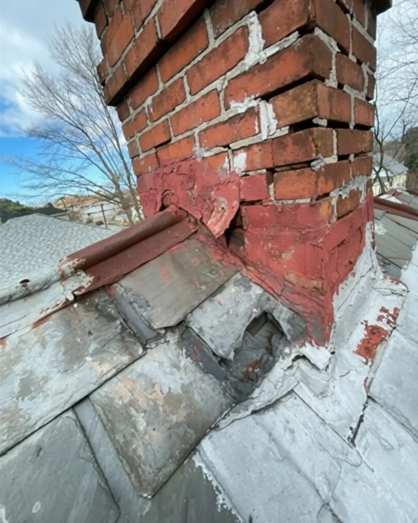 Deteriorated chimney flashing and damaged brick masonry showing gaps and failed counter flashing causing roof leak