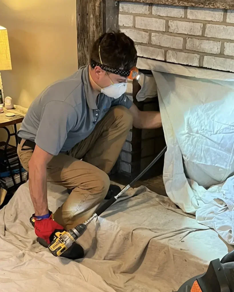 Rotary chimney cleaning using drill-powered chimney sweep equipment during chimney cleaning service in Virginia Beach VA