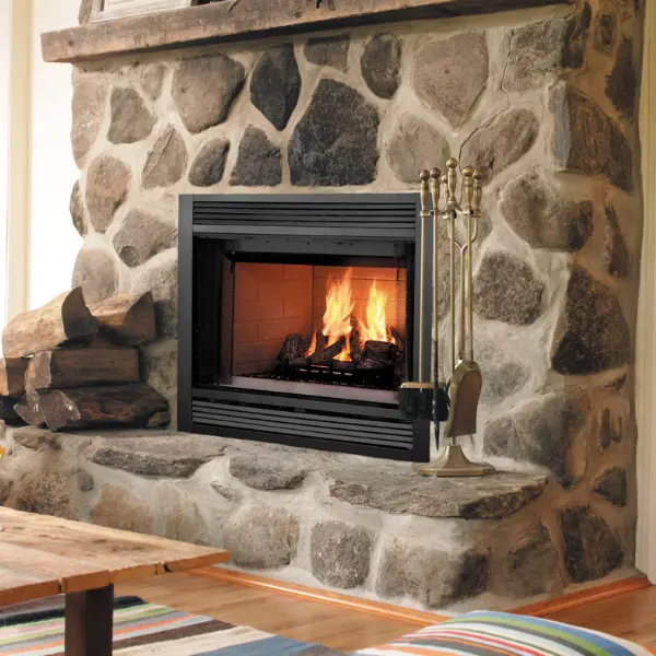 Majestic Sovereign wood-burning fireplace with natural stone surround and black trim